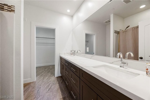 605 N Yale St, Las Vegas, NV 89107 - bathroom featuring double vanity, marble finish flooring, a walk in closet, and recessed lighting