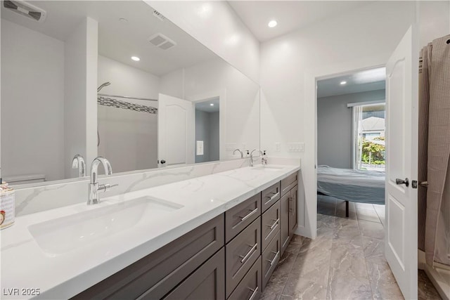 605 N Yale St, Las Vegas, NV 89107 - ensuite bathroom with double vanity, marble finish flooring, and recessed lighting