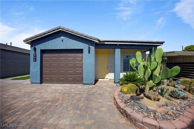 605 N Yale St, Las Vegas, NV 89107 - ranch-style house featuring an attached garage, stucco siding, and decorative driveway