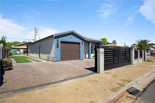 605 N Yale St, Las Vegas, NV 89107 - garage with decorative driveway and a gate