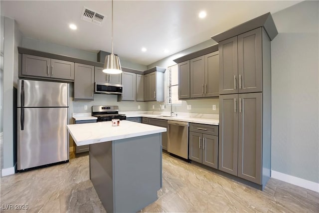 605 N Yale St, Las Vegas, NV 89107 - kitchen with appliances with stainless steel finishes, light countertops, a center island, gray cabinets, and light marble finish floors