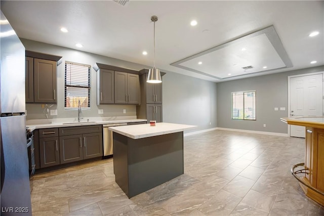 605 N Yale St, Las Vegas, NV 89107 - kitchen featuring appliances with stainless steel finishes, light countertops, a kitchen island, light marble finish flooring, and recessed lighting