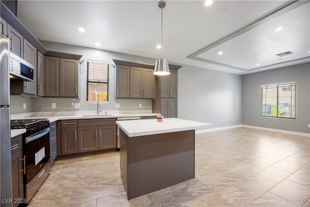 605 N Yale St, Las Vegas, NV 89107 - kitchen with appliances with stainless steel finishes, a kitchen island, light marble finish flooring, recessed lighting, and hanging light fixtures
