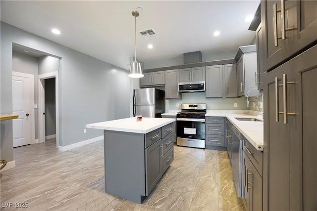 605 N Yale St, Las Vegas, NV 89107 - kitchen featuring stainless steel appliances, gray cabinetry, light countertops, a kitchen island, and decorative light fixtures