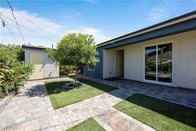 605 N Yale St, Las Vegas, NV 89107 - view of green lawn with a patio and a storage unit