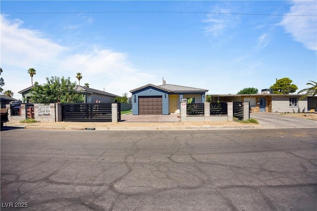 605 N Yale St, Las Vegas, NV 89107 - view of front of property featuring a garage, a fenced front yard, a gate, and driveway