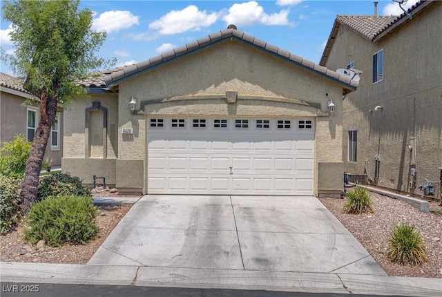 9420 Plover Falls Ave, Las Vegas, NV 89149 - view of front of property featuring an attached garage, driveway, stucco siding, and a tile roof