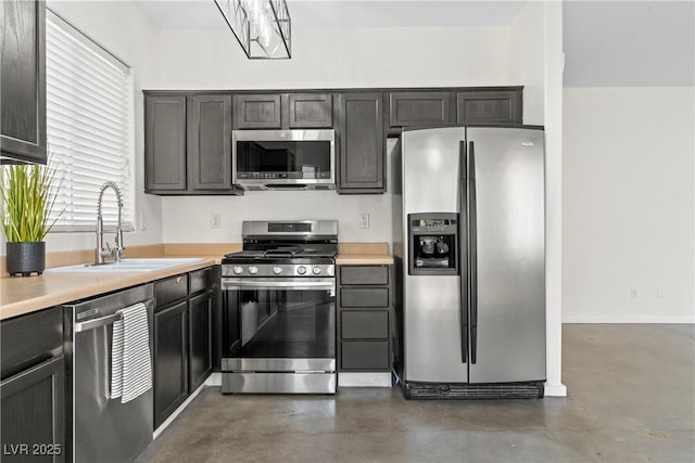 9420 Plover Falls Ave, Las Vegas, NV 89149 - kitchen with appliances with stainless steel finishes, concrete flooring, and light countertops