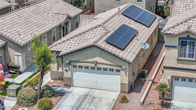 9420 Plover Falls Ave, Las Vegas, NV 89149 - view of front facade featuring solar panels, stucco siding, concrete driveway, and a tile roof