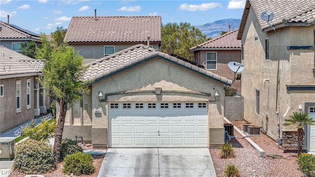9420 Plover Falls Ave, Las Vegas, NV 89149 - mediterranean / spanish-style house featuring an attached garage, concrete driveway, a mountain view, stucco siding, and a tile roof