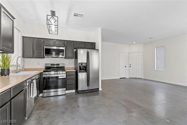 9420 Plover Falls Ave, Las Vegas, NV 89149 - kitchen with appliances with stainless steel finishes, finished concrete floors, and light countertops