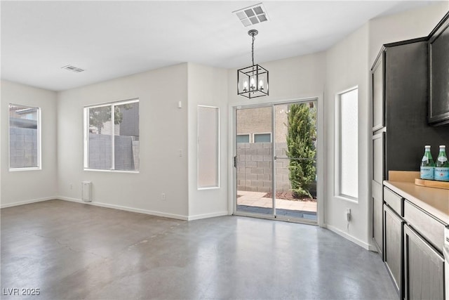 9420 Plover Falls Ave, Las Vegas, NV 89149 - unfurnished dining area with finished concrete floors and a chandelier
