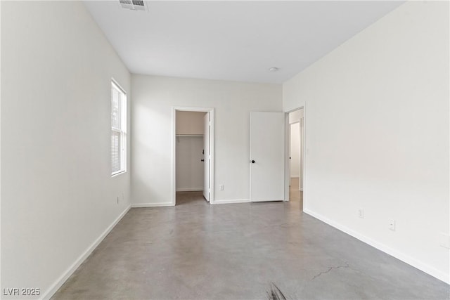 9420 Plover Falls Ave, Las Vegas, NV 89149 - unfurnished bedroom with finished concrete floors and a spacious closet