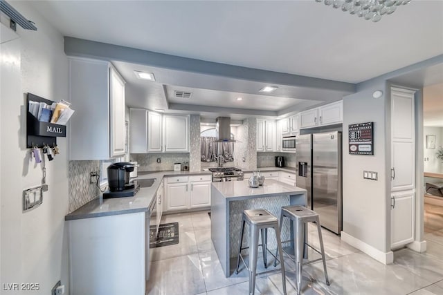 895 Beartooth Falls Ct, Henderson, NV 89052 - kitchen with appliances with stainless steel finishes, a raised ceiling, range hood, tasteful backsplash, and a center island
