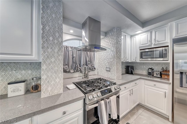 895 Beartooth Falls Ct, Henderson, NV 89052 - kitchen featuring stainless steel appliances, island exhaust hood, backsplash, and white cabinets