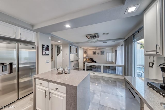 895 Beartooth Falls Ct, Henderson, NV 89052 - kitchen with built in refrigerator, light stone counters, open floor plan, white cabinets, and a kitchen island
