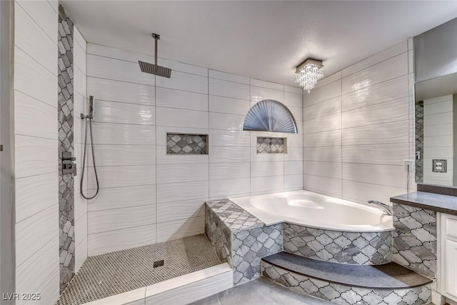 895 Beartooth Falls Ct, Henderson, NV 89052 - bathroom featuring a garden tub, vanity, tile walls, tiled shower, and a chandelier