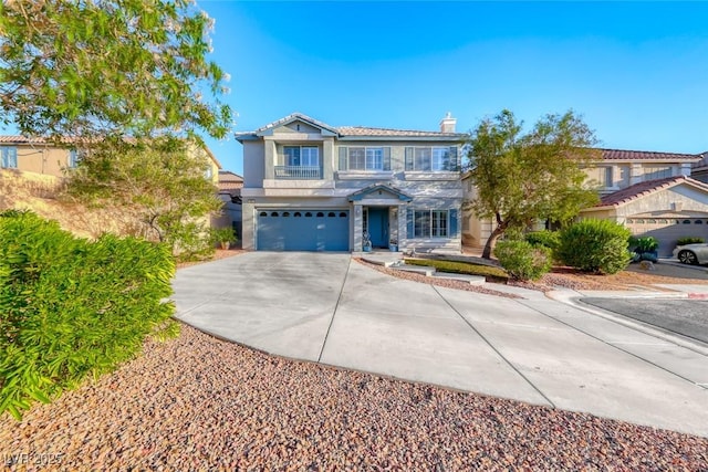895 Beartooth Falls Ct, Henderson, NV 89052 - view of front of house with driveway, an attached garage, stucco siding, and a chimney
