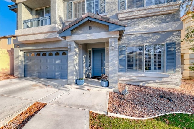 895 Beartooth Falls Ct, Henderson, NV 89052 - doorway to property featuring an attached garage, concrete driveway, stucco siding, and a balcony