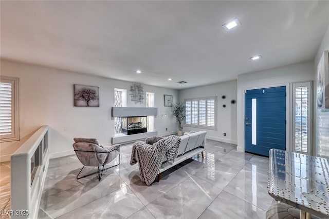 895 Beartooth Falls Ct, Henderson, NV 89052 - living room with recessed lighting, a fireplace with raised hearth, and light marble finish flooring