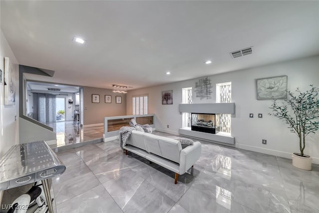 895 Beartooth Falls Ct, Henderson, NV 89052 - living room with marble tiled floors, healthy amount of natural light, recessed lighting, and a fireplace with raised hearth