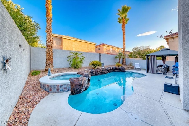 895 Beartooth Falls Ct, Henderson, NV 89052 - view of swimming pool featuring a gazebo, a fenced backyard, a patio area, and a pool with connected hot tub