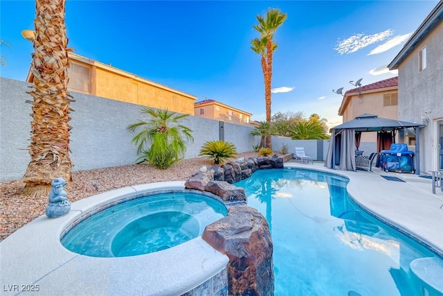 895 Beartooth Falls Ct, Henderson, NV 89052 - view of swimming pool featuring a gazebo, a fenced backyard, a patio, and a pool with connected hot tub
