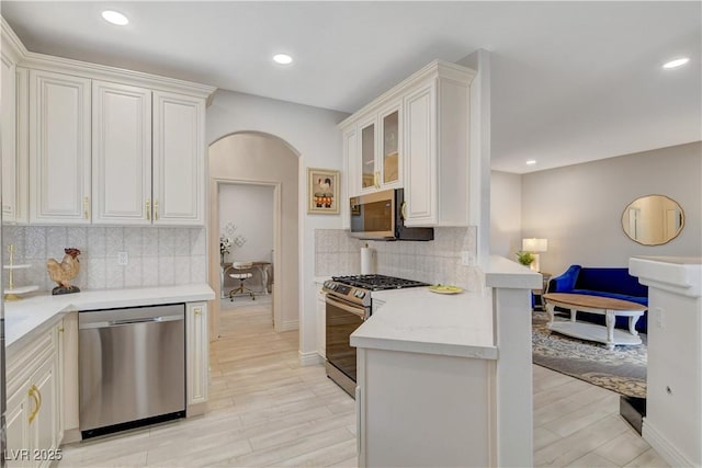 9000 Las Vegas Blvd Unit 2060, Las Vegas, NV 89123 - kitchen featuring stainless steel appliances, arched walkways, a peninsula, recessed lighting, and backsplash