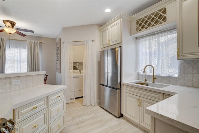 9000 Las Vegas Blvd Unit 2060, Las Vegas, NV 89123 - kitchen with freestanding refrigerator, washing machine and dryer, ceiling fan, decorative backsplash, and light wood-style floors