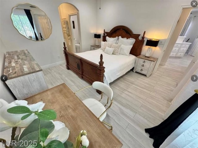9000 Las Vegas Blvd Unit 2060, Las Vegas, NV 89123 - bedroom with arched walkways, light wood finished floors, and connected bathroom