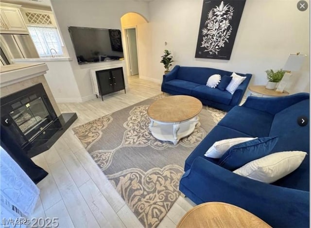9000 Las Vegas Blvd Unit 2060, Las Vegas, NV 89123 - living room with arched walkways, light wood-type flooring, and a glass covered fireplace
