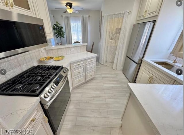 9000 Las Vegas Blvd Unit 2060, Las Vegas, NV 89123 - kitchen with stainless steel appliances, decorative backsplash, ceiling fan, and light stone countertops