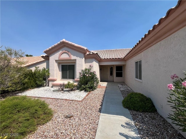 2712 Breakers Creek Dr, Las Vegas, NV 89134 - view of exterior entry with stucco siding and a tiled roof