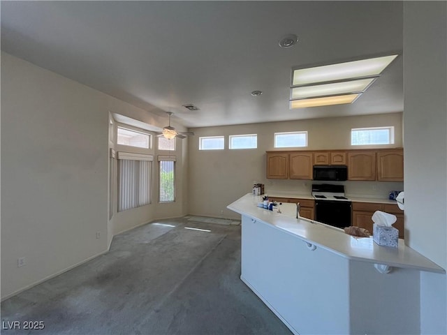 2712 Breakers Creek Dr, Las Vegas, NV 89134 - kitchen with range with electric cooktop, black microwave, a ceiling fan, carpet, and a peninsula