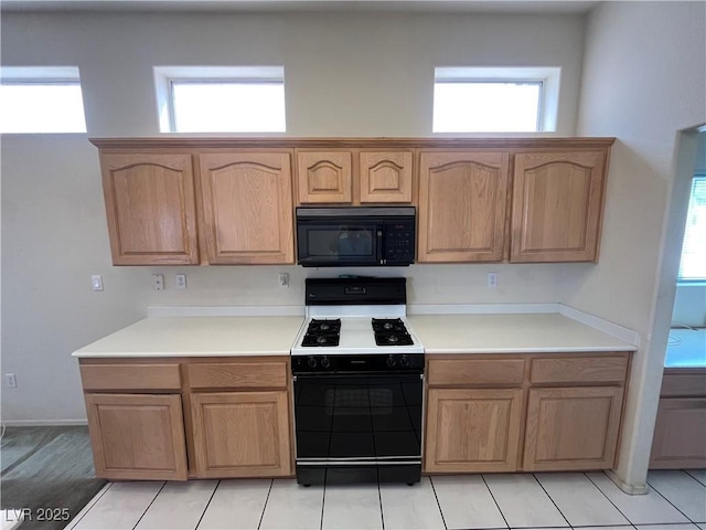 2712 Breakers Creek Dr, Las Vegas, NV 89134 - kitchen featuring black microwave, range with gas cooktop, plenty of natural light, and light countertops
