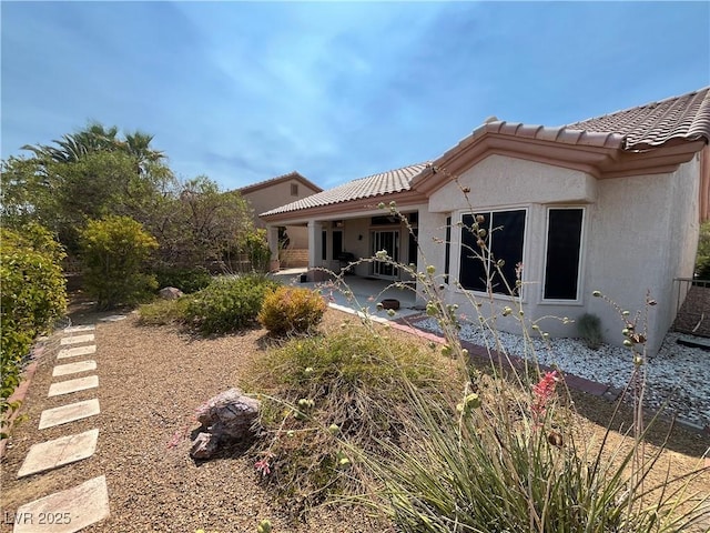 2712 Breakers Creek Dr, Las Vegas, NV 89134 - rear view of property featuring a patio area, stucco siding, and a tile roof