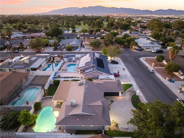 1009 Ironwood Dr, Las Vegas, NV 89108 - aerial view at dusk of view of pool, a mountain view, and a residential view