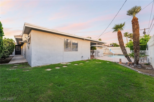 1009 Ironwood Dr, Las Vegas, NV 89108 - view of side of home with a fenced backyard, stucco siding, and a patio area