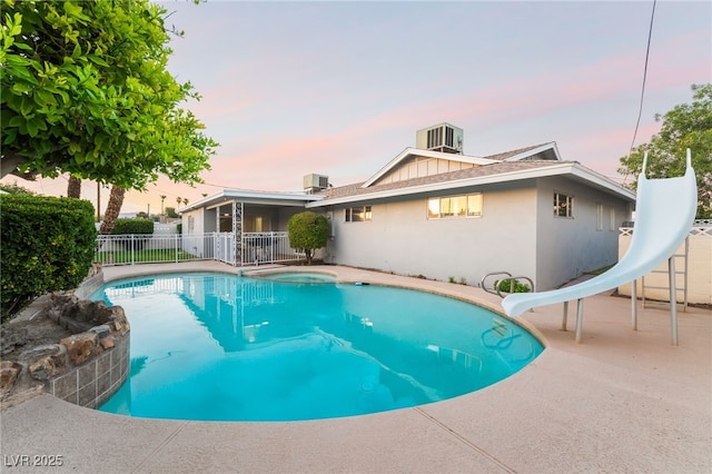 1009 Ironwood Dr, Las Vegas, NV 89108 - pool at dusk with a water slide and a patio