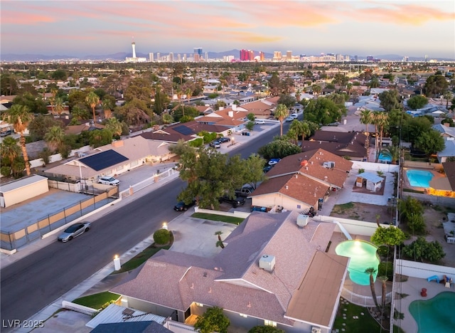 1009 Ironwood Dr, Las Vegas, NV 89108 - aerial view at dusk of view of pool area, a city view, and a residential view