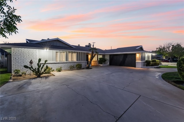 1009 Ironwood Dr, Las Vegas, NV 89108 - ranch-style home featuring brick siding, board and batten siding, concrete driveway, and an attached garage