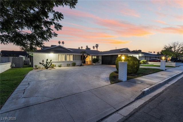 1009 Ironwood Dr, Las Vegas, NV 89108 - single story home with an attached garage, driveway, and board and batten siding