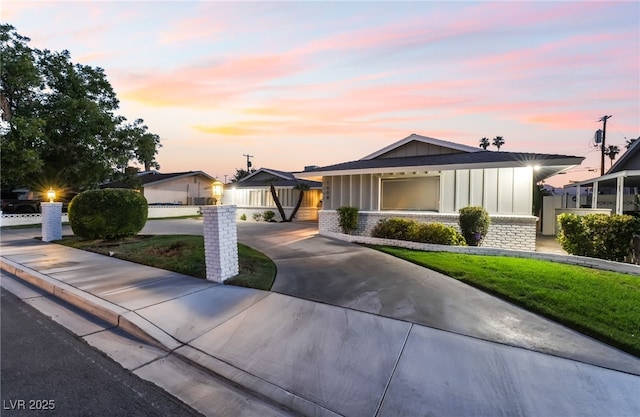 1009 Ironwood Dr, Las Vegas, NV 89108 - view of front of property with board and batten siding and curved driveway