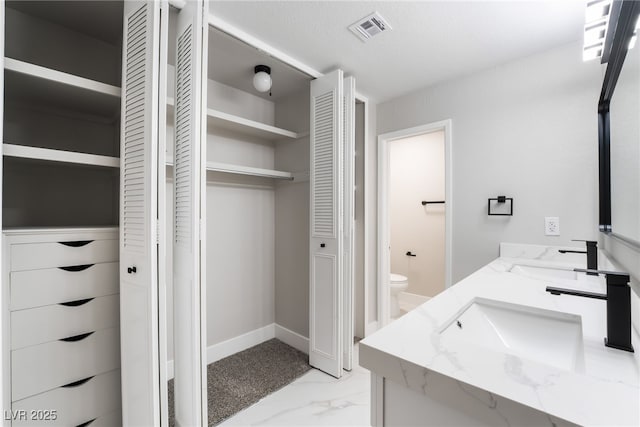 1009 Ironwood Dr, Las Vegas, NV 89108 - bathroom with a closet, double vanity, and marble finish flooring