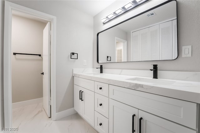 1009 Ironwood Dr, Las Vegas, NV 89108 - bathroom with double vanity, marble finish floors, and a closet