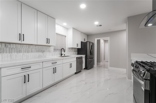 1009 Ironwood Dr, Las Vegas, NV 89108 - kitchen featuring stainless steel appliances, exhaust hood, tasteful backsplash, recessed lighting, and light marble finish floors