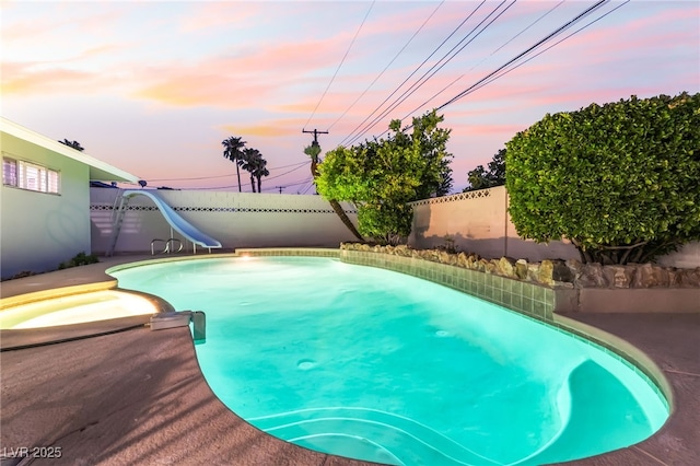 1009 Ironwood Dr, Las Vegas, NV 89108 - view of pool featuring a water slide, a fenced backyard, and a pool with connected hot tub