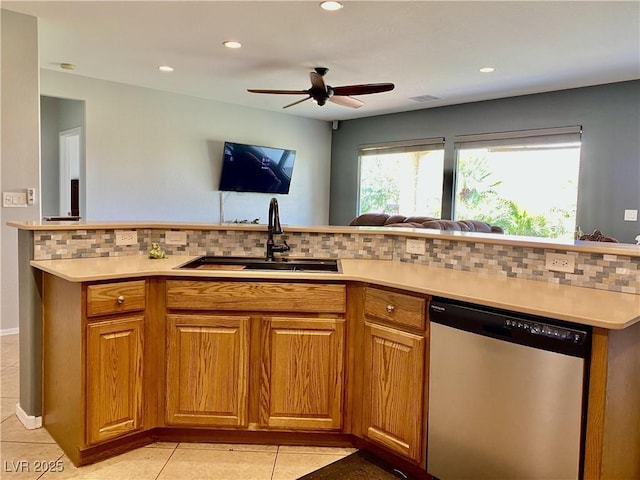2345 Minolta Ct, Henderson, NV 89044 - kitchen with stainless steel dishwasher, light tile patterned flooring, backsplash, light countertops, and open floor plan