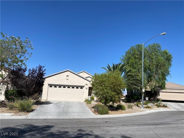 2345 Minolta Ct, Henderson, NV 89044 - view of front facade with a garage, concrete driveway, and stucco siding