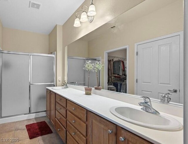 2345 Minolta Ct, Henderson, NV 89044 - full bath with double vanity, a shower stall, a walk in closet, and tile patterned floors